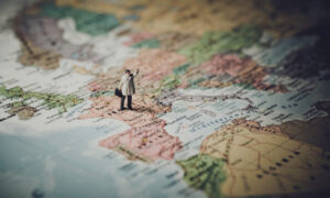Miniature businessman on map of Europe Miniature businessman on map of Europe